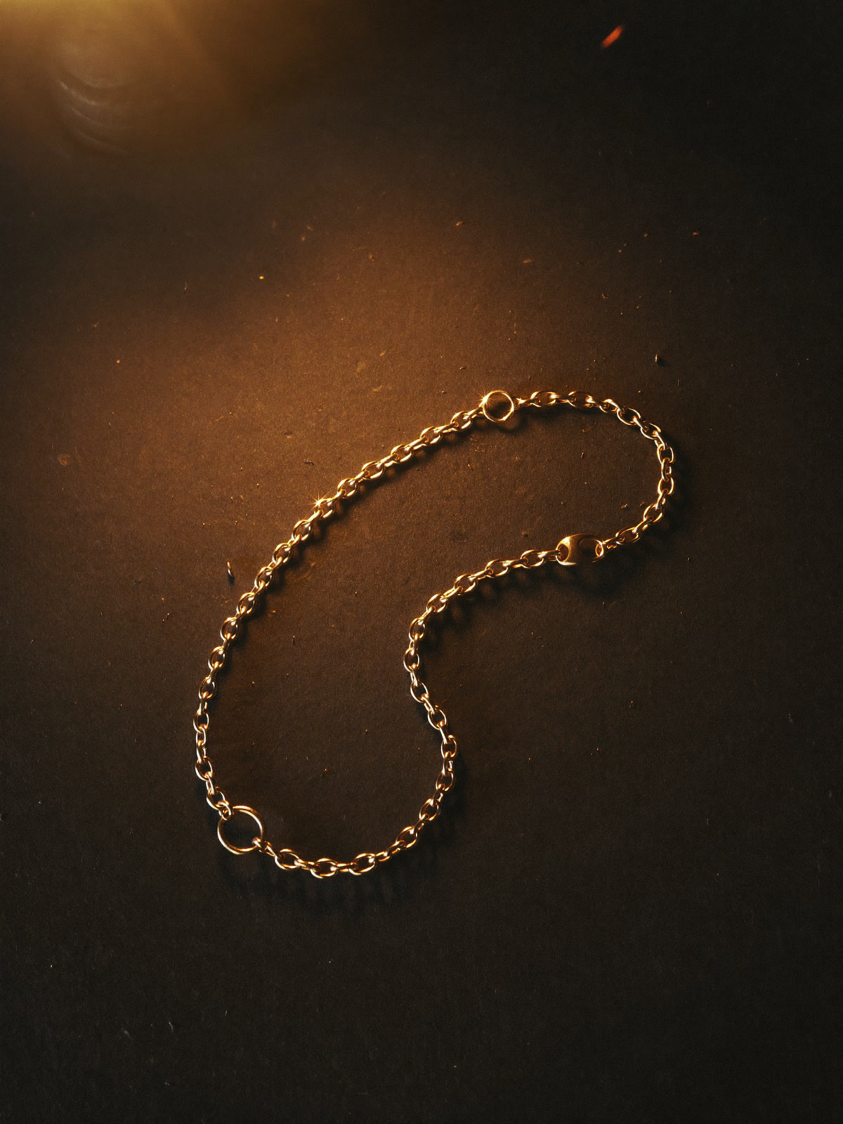 Study of a gold chain resting on dark velvet